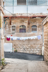 Fototapeta na wymiar Laundry hanging to dry in an old city alley