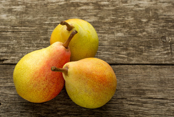 Juicy fresh pears on a dark wooden background