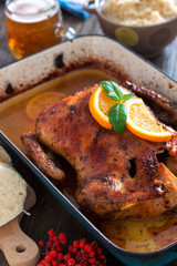 Delicious roasted duck with oranges in a pan, rustic style