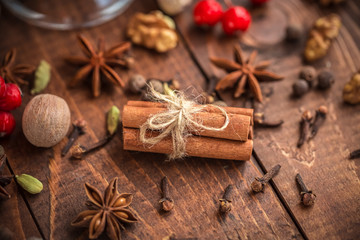 Collection of spices for mulled wine and pastry on the wooden table