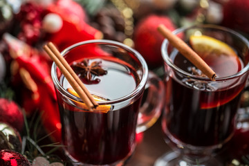Christmas hot mulled wine with spices on a wooden table. The idea for creating greeting cards
