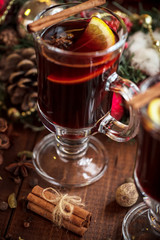 Christmas hot mulled wine with spices on a wooden table. The idea for creating greeting cards