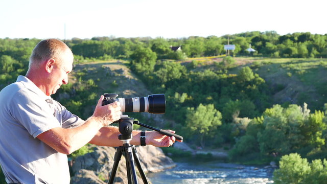 

Adult man  photographer  shoot  landscape and go away. 4K 3840x2160
