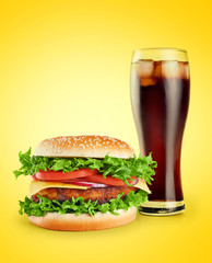 Hamburger and cola on a yellow background.