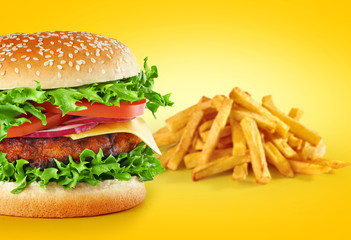 Hamburger with fries on a yellow background.