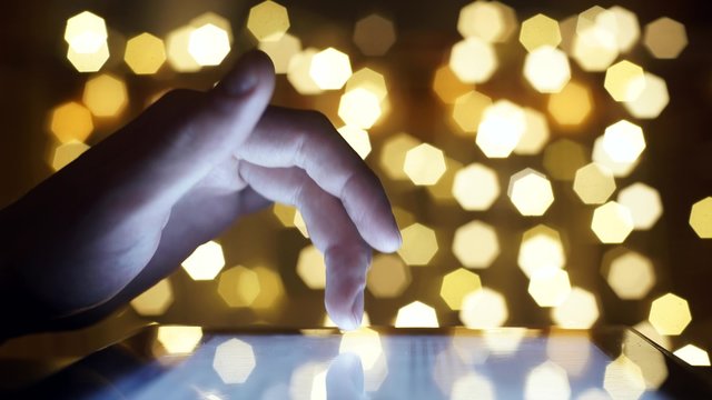 Closeup Finger Touching Tablet Computer Touchscreen on christmas