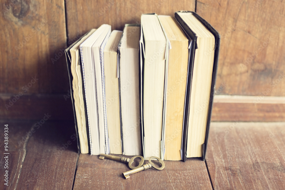 Poster old books with old style keys on the wooden floor