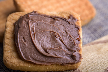 biscuit with chocolate cream on cloth napkin