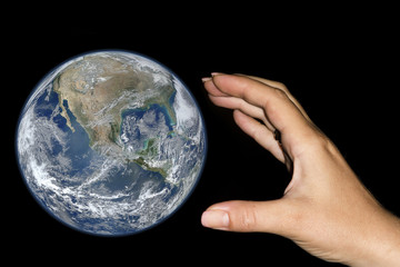 Hand catching the earth. Elements furnished by NASA