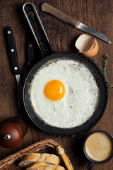 Breakfast setting with fried egg and coffee