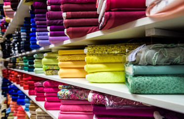 Rolls of fabric and textiles in a factory shop or  store