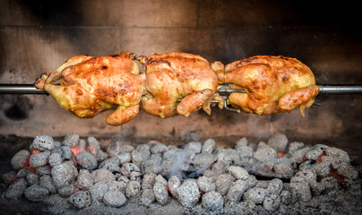 Cooking 3 rotisserie chicken on the grill with Charcoal and Briq