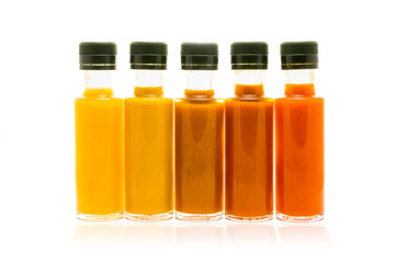 Different color home made hot sauce in glass bottles