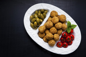 healthy italian appetizer with risotto balls arancini , green ol
