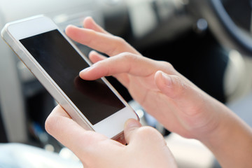 women using a mobile phone in the car