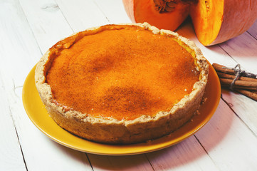 Pumpkin pie on white wooden table