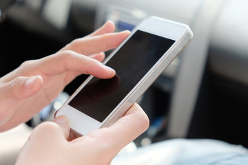 Woman making a phone call in the car.