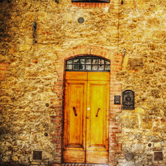 wooden doors in a brick wall in San Gimignano