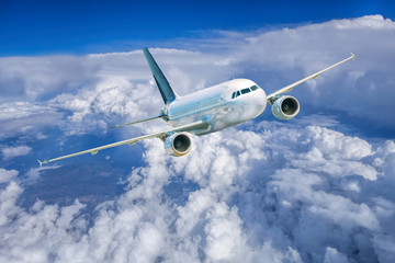 Fototapeta na wymiar Airplane in the sky against cloudy