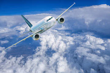 Fototapeta na wymiar Airplane in the sky against cloudy