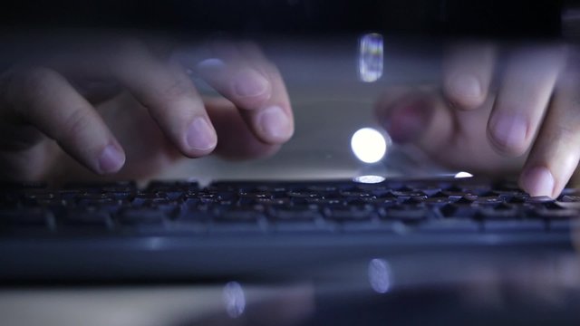Hands typing on keyboard