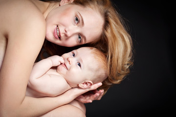 Happy mother with newborn on hands 