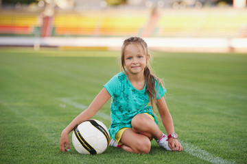 little funny girl on football stadium