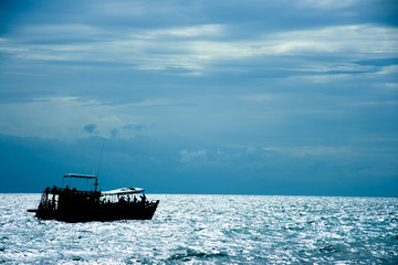 A scuba diving boat, is moving to next diving site after its afternoon break. This one-day boat provides a saloon where divers take a rest above its control room.