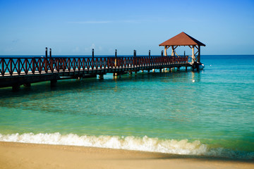 Long wooden jetty for ships, stretching into the sea