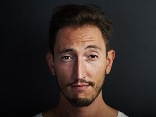 Fototapeta premium Portrait of cute young man wearing white tshirt and playing on the camera. Horizontal