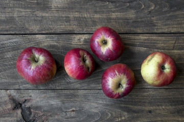 Organic red apples on table