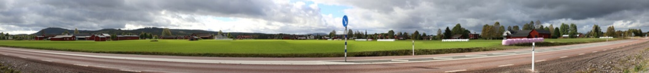 Obraz premium Panoramic view of field and houses at the highway near Aeppelbo, Dalarna, Sweden