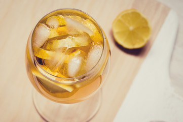 White Sangria with slices of lemon and ice closeup