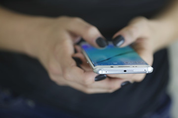 Woman holding mobile cellphone and tipping