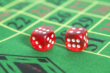 roll of the red dice on  game table in  casino