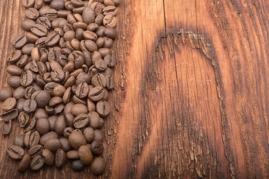 Coffee bean background on wooden texture