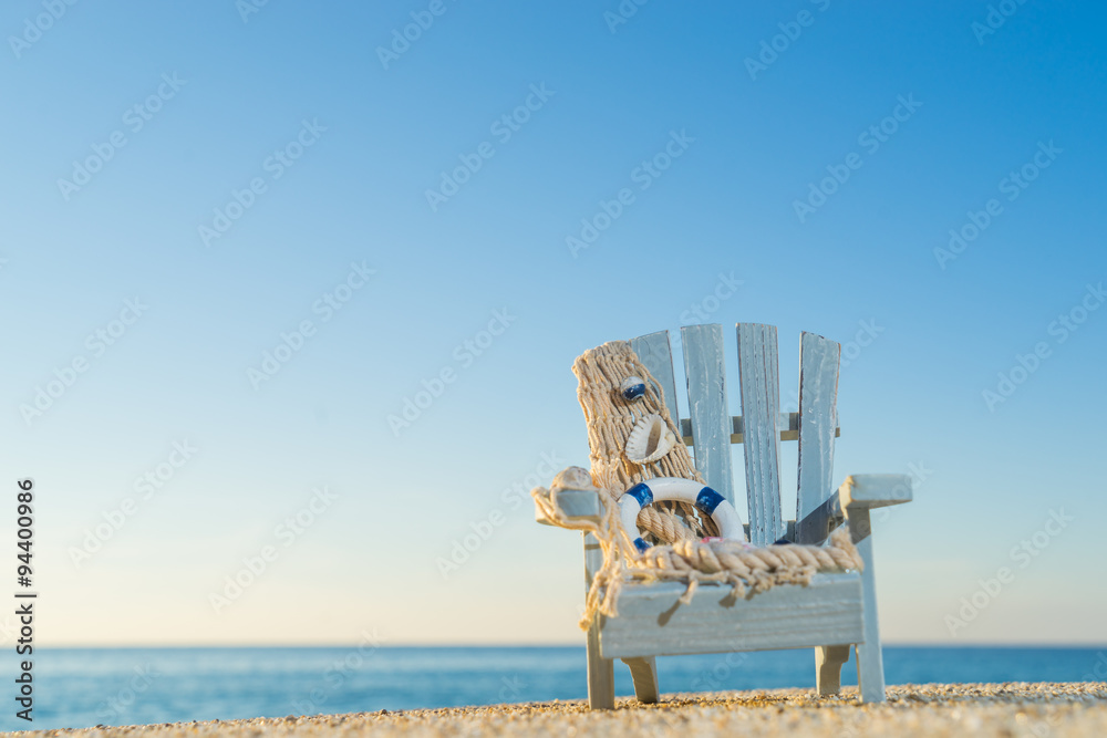 Wall mural tropical beach with a sun-lounger facing the blue sea