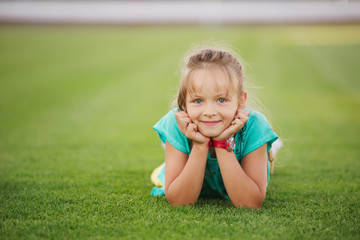little funny girl on football stadium