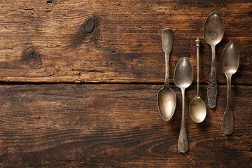 Metal spoons on wooden table