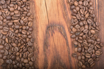Coffee bean background on wooden texture