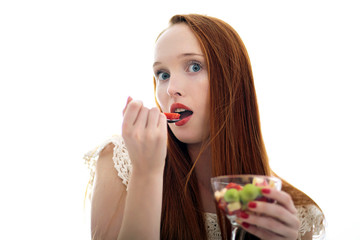Attractive beautiful long haired woman holding a glass fruit cup