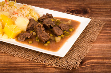Venison Goulash with potatoes on the white plate.
