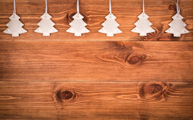 Christmas decoration- silver metal fir-trees on the wooden background - the picture may be used for...