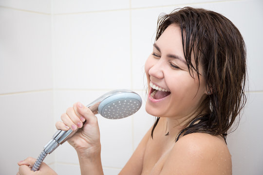 portrait of happy woman singing in shower