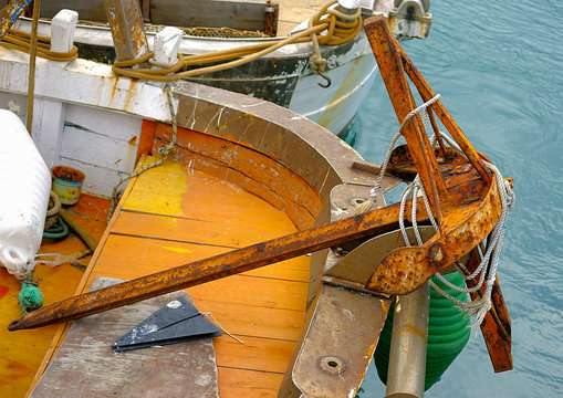 Old still used resting on the edge fishing boat moored