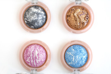 pink,grey,blue,golden eye shadows kit on white background