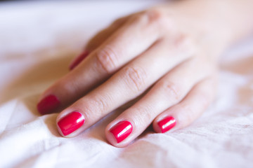 Obraz na płótnie Canvas Female hand with red nails