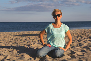 Fototapeta na wymiar Portrait of beautiful blonde woman on the summer beach