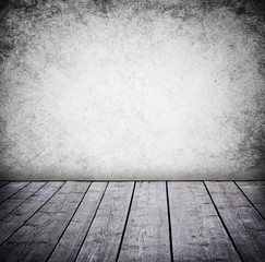 Grunge wall and wood paneled floor, interior of a room.
