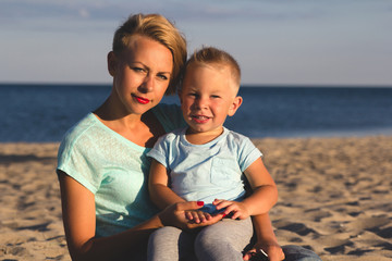 Happy family resting at beach in summer